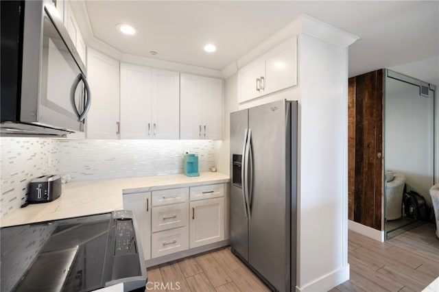 kitchen featuring light hardwood / wood-style floors, white cabinetry, and stainless steel appliances