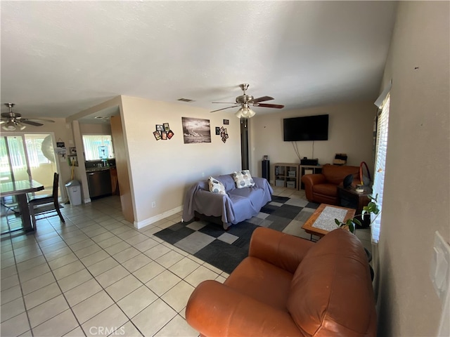 living room with ceiling fan and light tile patterned flooring