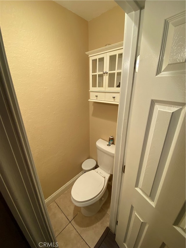 bathroom with tile patterned flooring and toilet