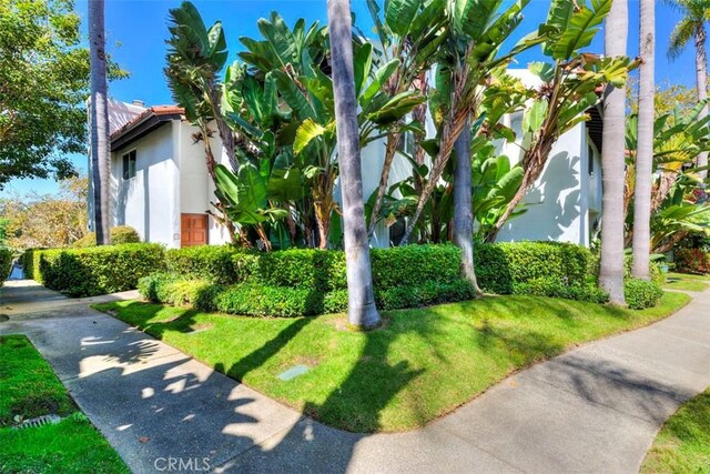 view of side of home with a lawn