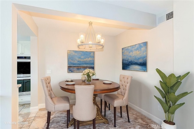 dining area with an inviting chandelier, baseboards, and visible vents