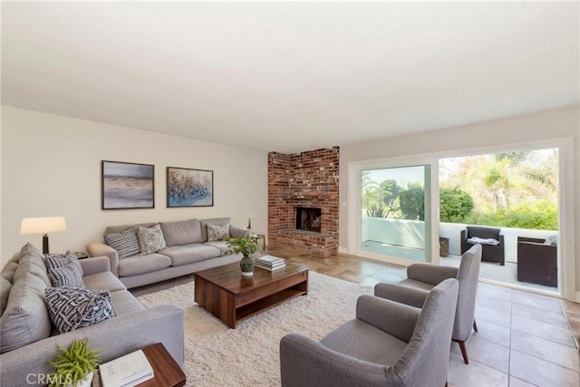 living room with light tile patterned floors and a brick fireplace