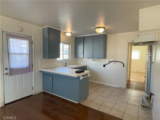 kitchen featuring light tile patterned flooring, sink, and kitchen peninsula