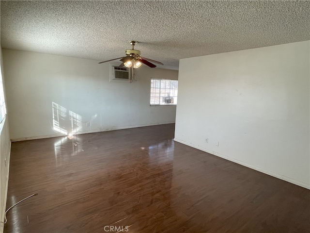 unfurnished room with dark hardwood / wood-style flooring, ceiling fan, a textured ceiling, and a wall mounted air conditioner