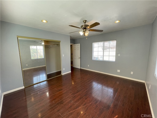 unfurnished bedroom featuring ceiling fan, dark wood-type flooring, and a closet