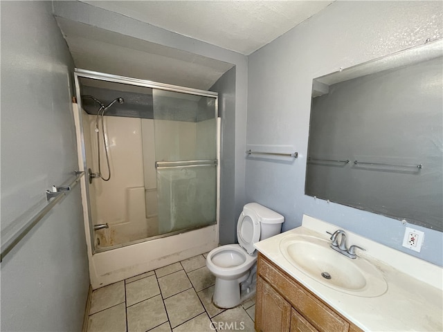 full bathroom featuring vanity, tile patterned flooring, toilet, and enclosed tub / shower combo