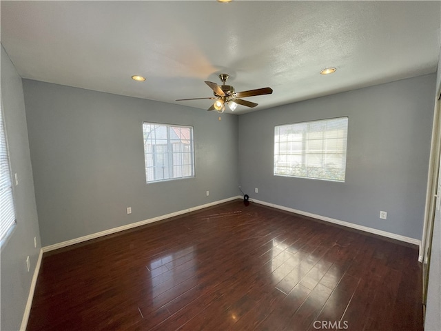 unfurnished room with ceiling fan, dark hardwood / wood-style floors, and a textured ceiling