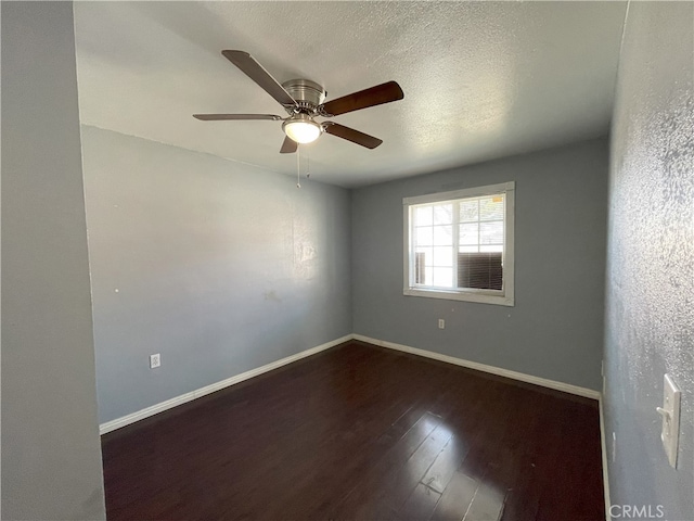 unfurnished room with a textured ceiling, ceiling fan, and dark hardwood / wood-style flooring