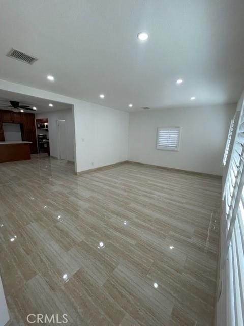 unfurnished living room featuring ceiling fan, baseboards, visible vents, and recessed lighting