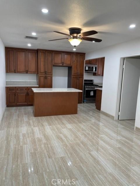 kitchen featuring ceiling fan, stainless steel appliances, light countertops, visible vents, and recessed lighting