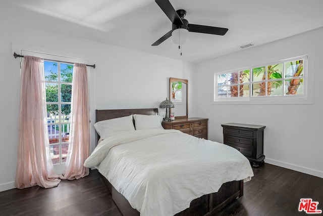 bedroom with ceiling fan and dark hardwood / wood-style flooring