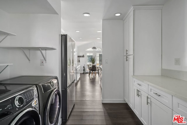 washroom featuring dark hardwood / wood-style floors and washer and clothes dryer