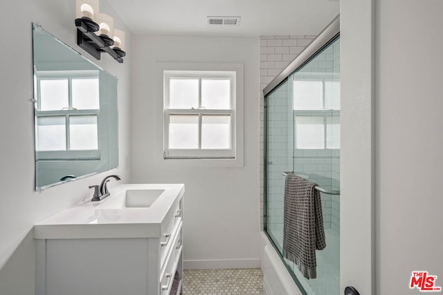 bathroom featuring shower / bath combination with glass door, vanity, and tile patterned floors