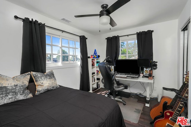 bedroom with ceiling fan and hardwood / wood-style flooring