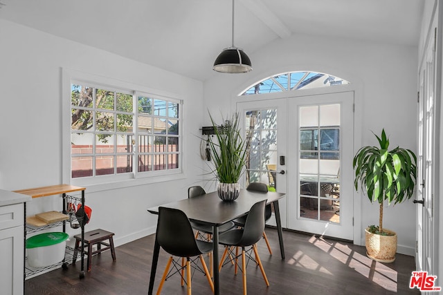 dining area with lofted ceiling with beams, dark hardwood / wood-style floors, and french doors