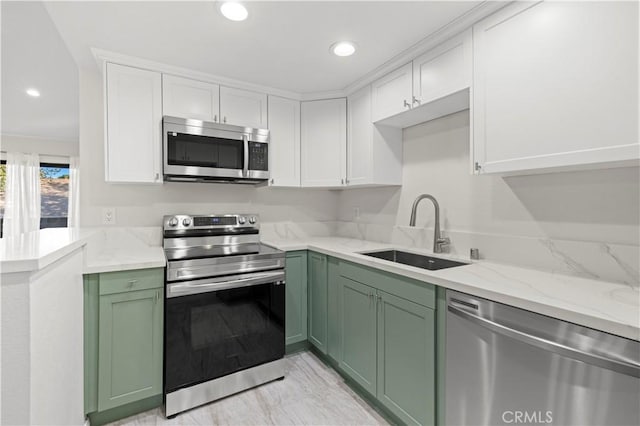 kitchen with green cabinets, white cabinetry, sink, and appliances with stainless steel finishes