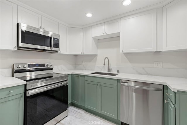 kitchen featuring white cabinets, stainless steel appliances, green cabinets, and sink