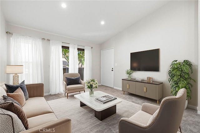 carpeted living room featuring vaulted ceiling