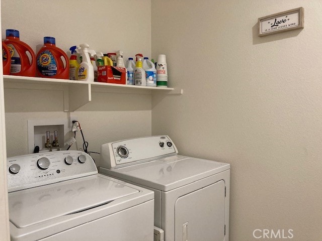 clothes washing area with washer and clothes dryer