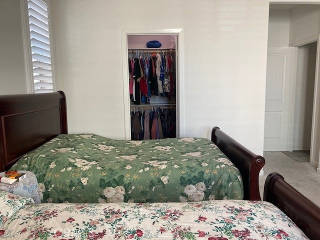 carpeted bedroom with a closet