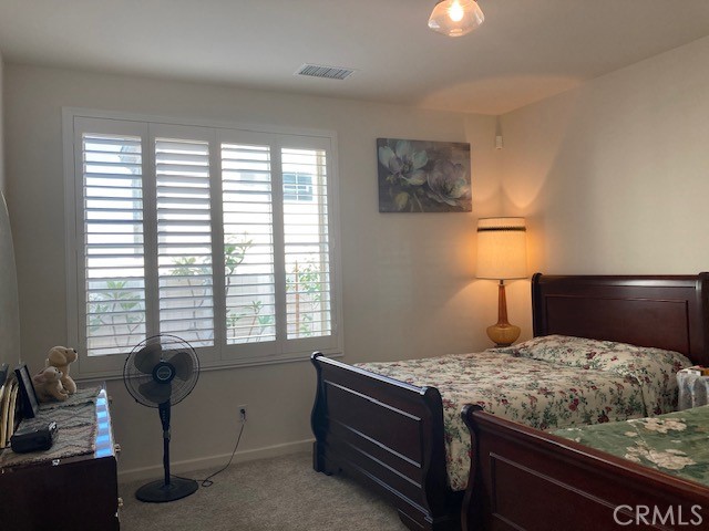 bedroom featuring light carpet