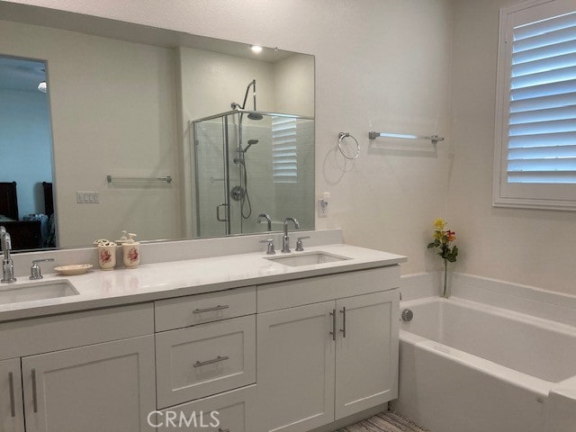 bathroom with vanity and independent shower and bath