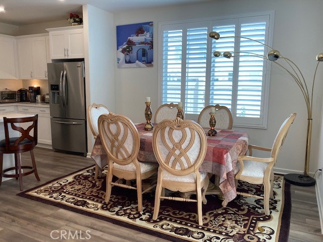 dining space featuring dark hardwood / wood-style flooring and plenty of natural light