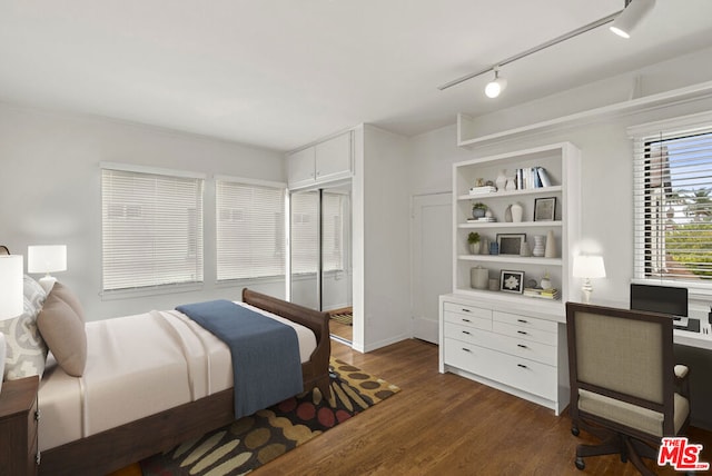 bedroom with a closet and dark hardwood / wood-style floors