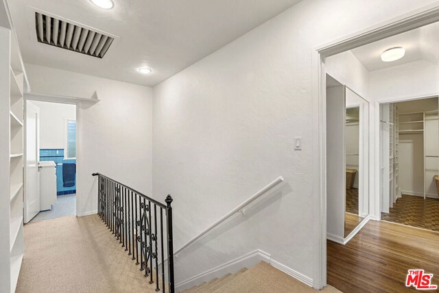 corridor featuring hardwood / wood-style floors