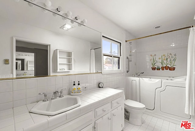 full bathroom with vanity, toilet, backsplash, tile walls, and tile patterned flooring