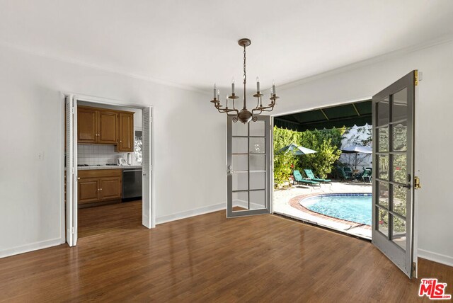 unfurnished dining area with ornamental molding and dark hardwood / wood-style flooring