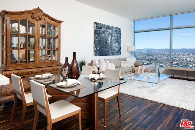 dining area with dark wood-type flooring and expansive windows