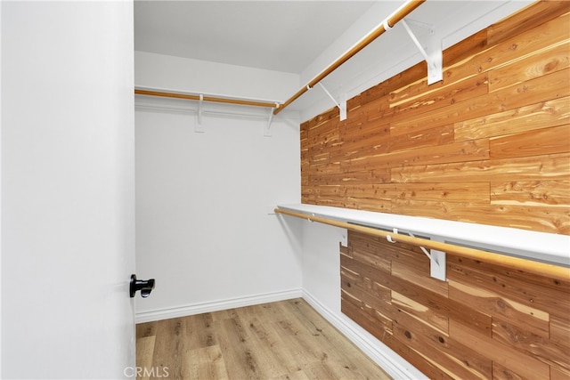 spacious closet with light hardwood / wood-style floors