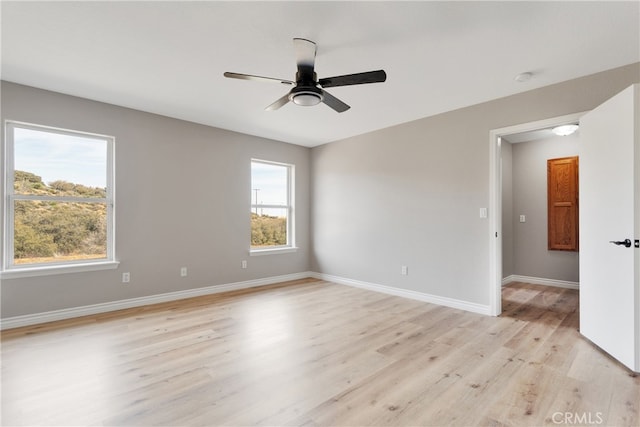 unfurnished room with ceiling fan, light hardwood / wood-style flooring, and a healthy amount of sunlight