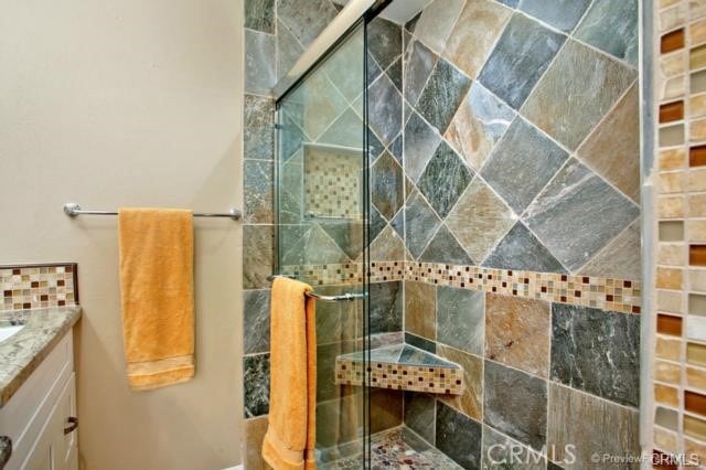 bathroom with vanity and a shower with shower door