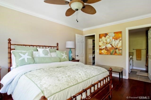 bedroom with connected bathroom, hardwood / wood-style flooring, ceiling fan, and crown molding