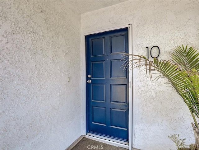 entrance to property with stucco siding
