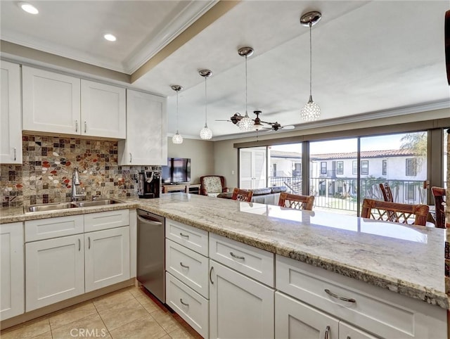 kitchen with white cabinetry, stainless steel dishwasher, ornamental molding, a sink, and ceiling fan