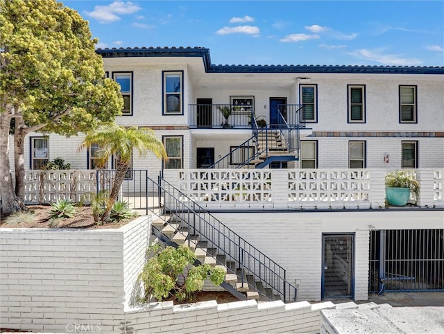 view of front of house featuring stairway and stucco siding