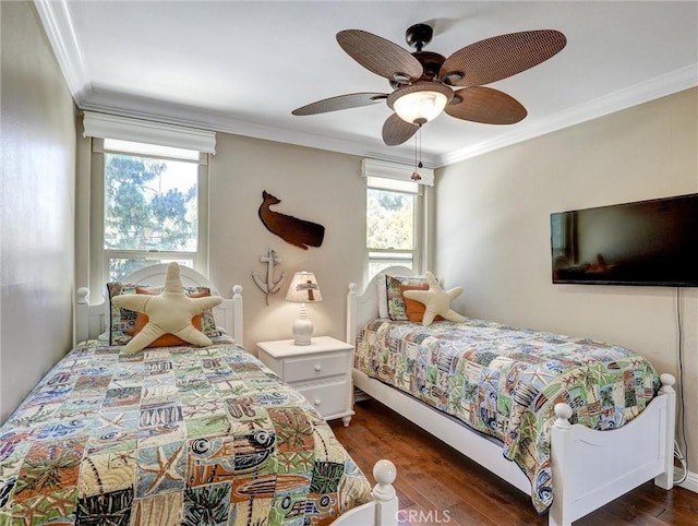 bedroom with crown molding, dark wood-style floors, and a ceiling fan
