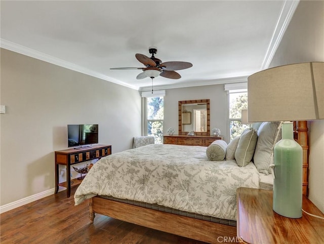 bedroom with dark wood-style flooring, ornamental molding, multiple windows, and baseboards