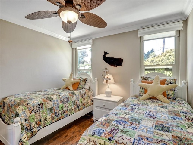 bedroom with a ceiling fan, ornamental molding, and dark wood-style floors