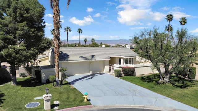 view of front of property with a garage and a front lawn