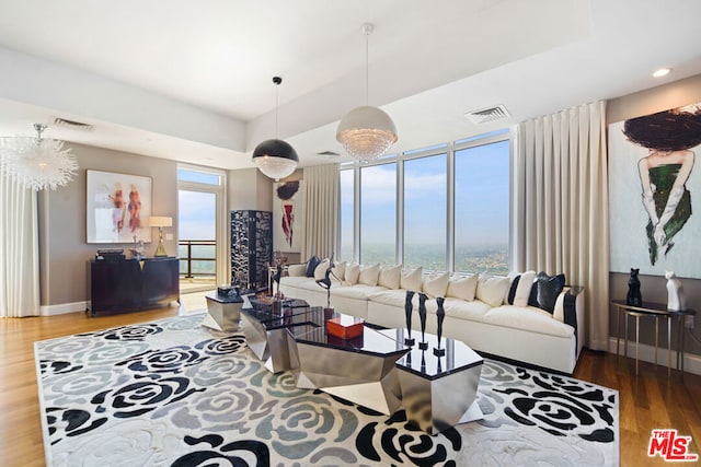 living room featuring wood-type flooring and a chandelier