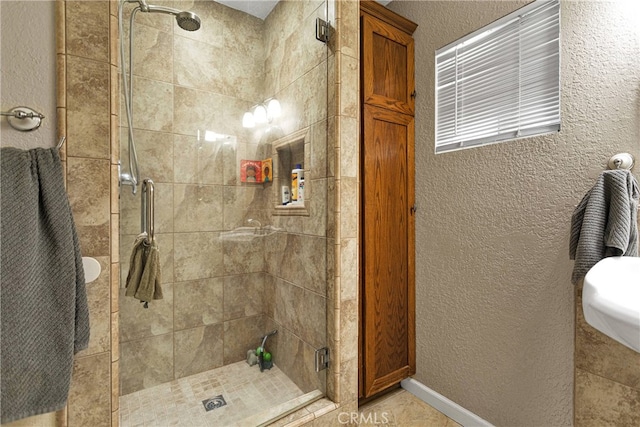 bathroom with a shower with door