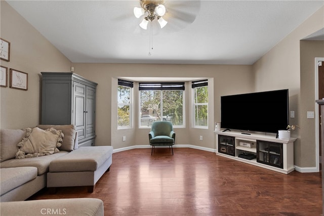 living room featuring ceiling fan, dark hardwood / wood-style floors, and vaulted ceiling