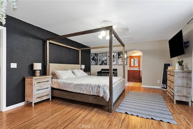 bedroom featuring wood-type flooring, ceiling fan, and ensuite bathroom