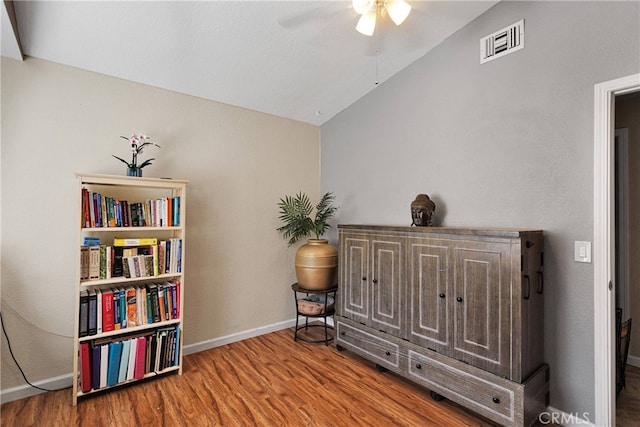 sitting room featuring wood-type flooring, lofted ceiling, and ceiling fan