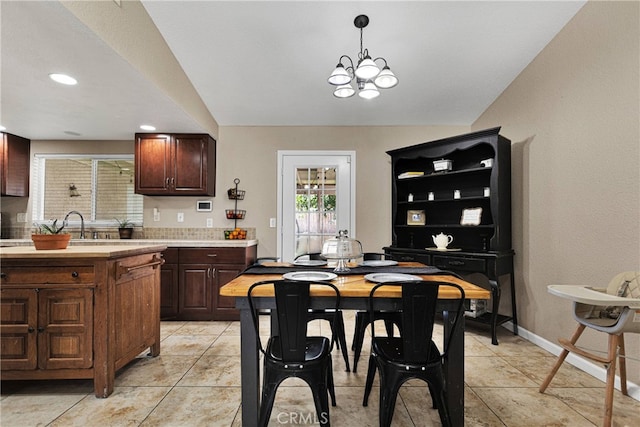 dining area featuring an inviting chandelier and light tile patterned flooring