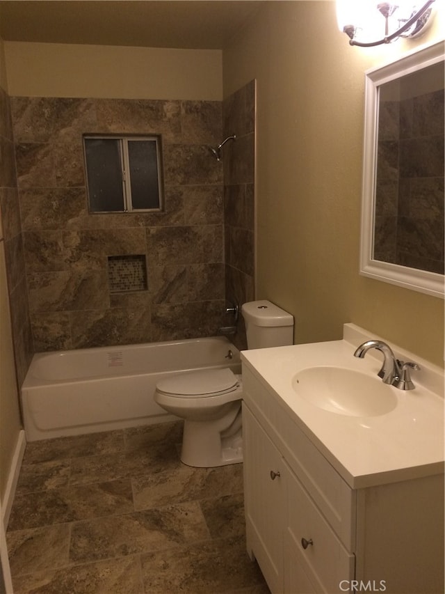 full bathroom with tiled shower / bath combo, vanity, and toilet